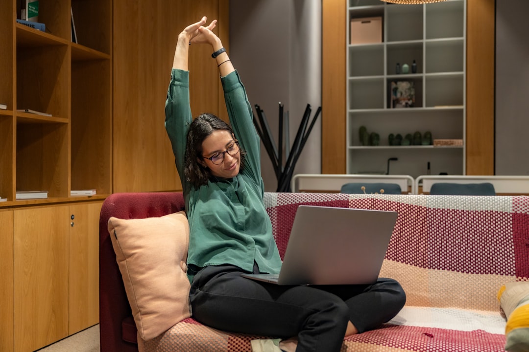 Adult stretching beside a desk after sitting, illustrating a common change in position
