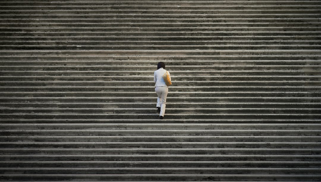 Person walking up outdoor stairs during an everyday activity
